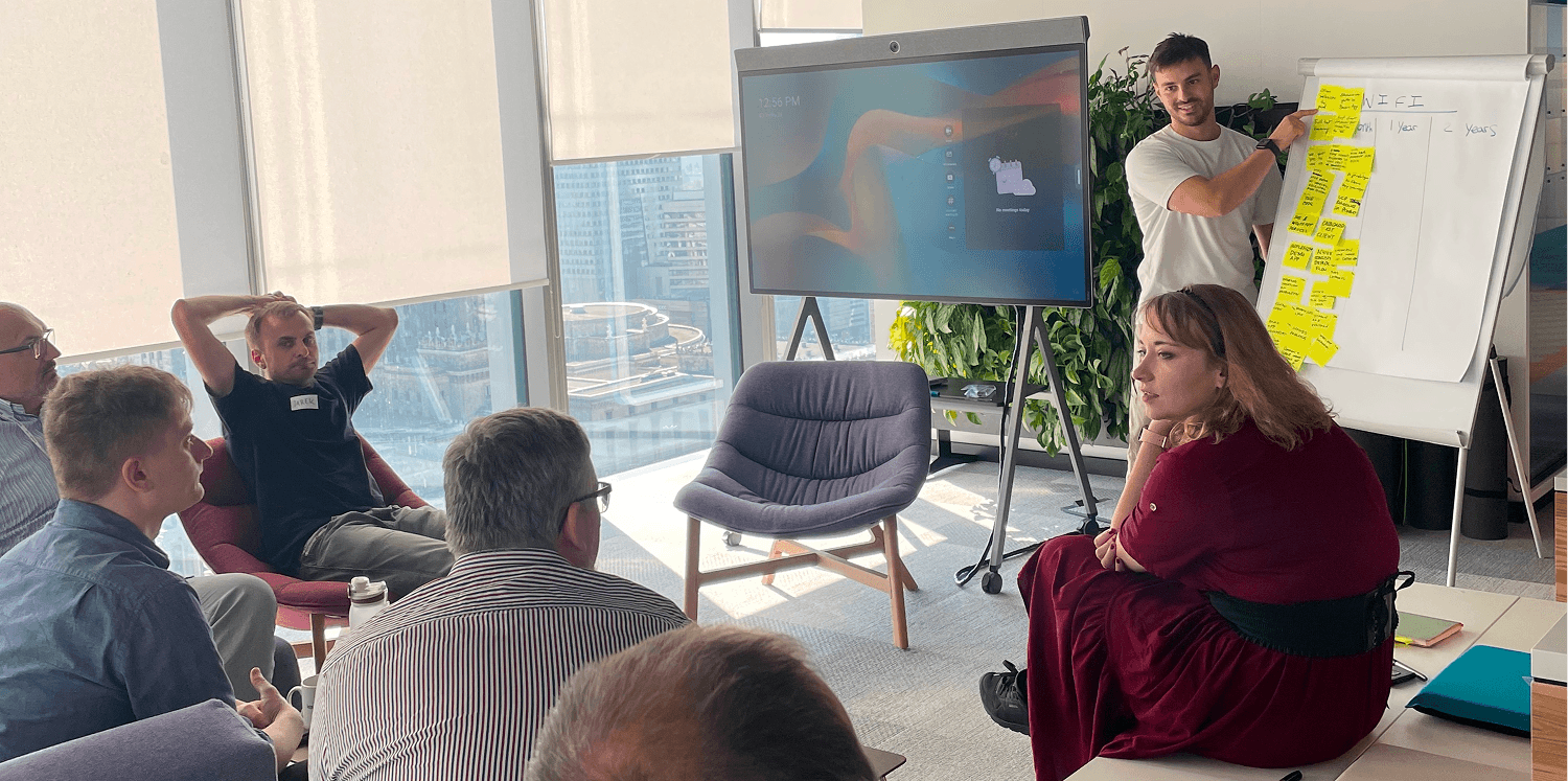 Dan presenting UX research findings to a Polish development team